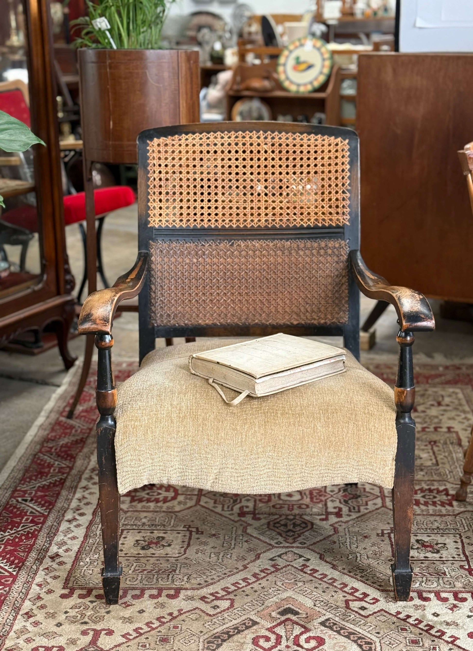 Antique Bergere chair with a caned back, upholstered seat, and a vintage aesthetic, perfect for home decor.