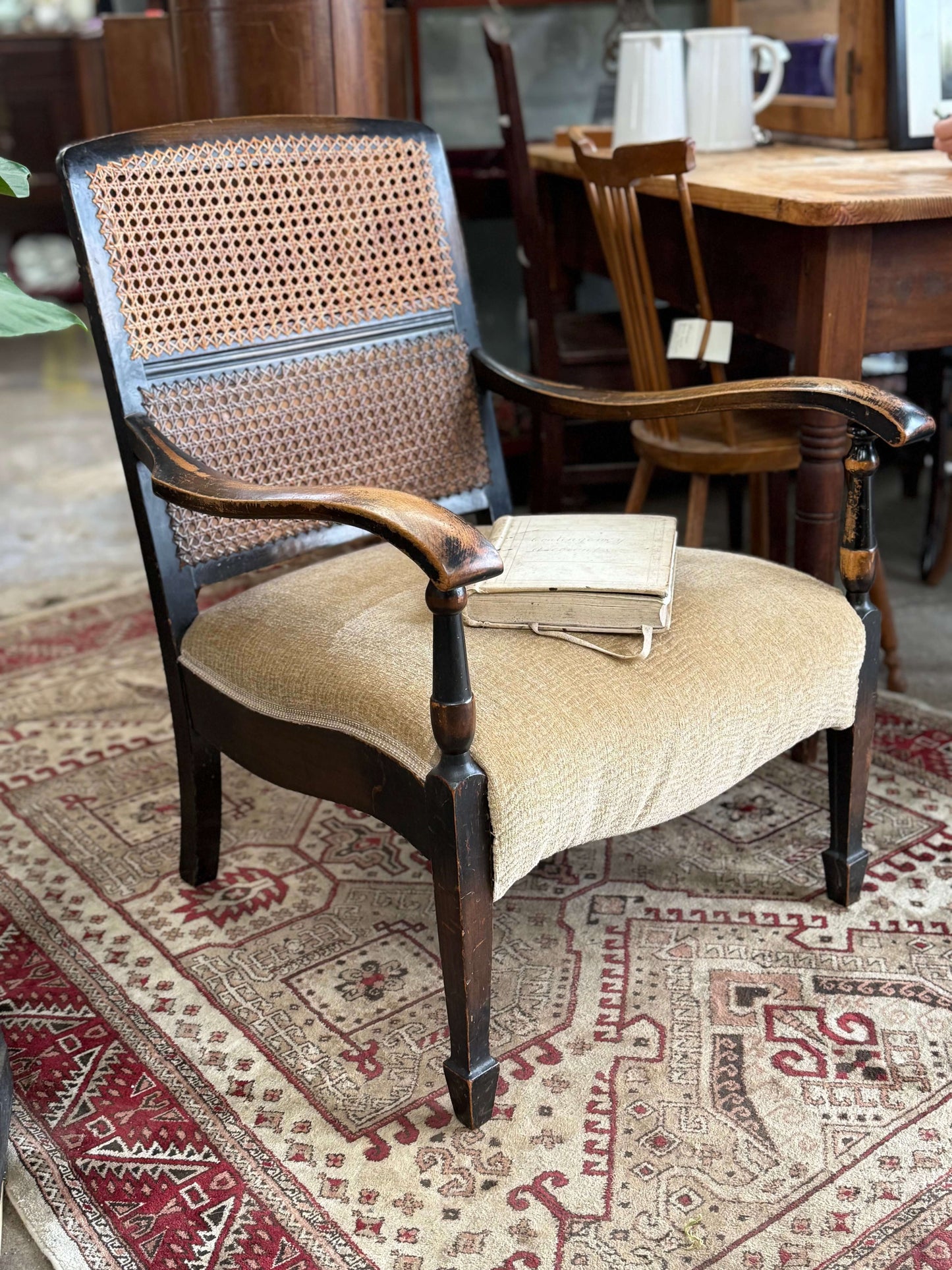 Elegant antique Bergere chair with cane back and upholstery, circa 1900, showcasing vintage charm and sturdy construction.