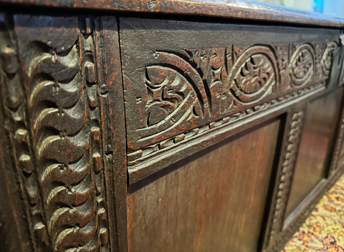 Beautiful antique carved oak coffer, late 17th/early 18th century, with original candle box, iron pin hinges, and sturdy craftsmanship